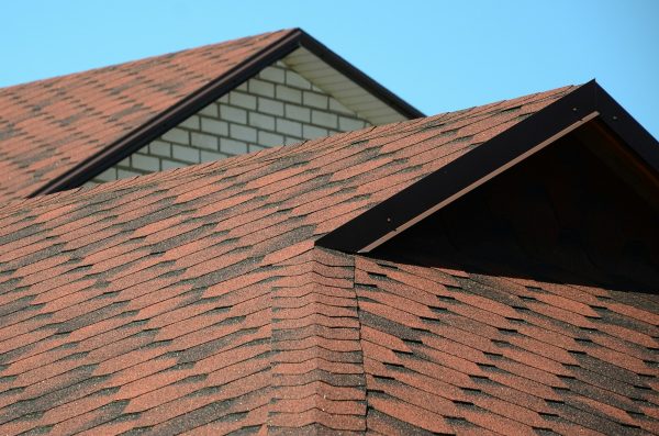 The roof is covered with bituminous shingles of brown color.